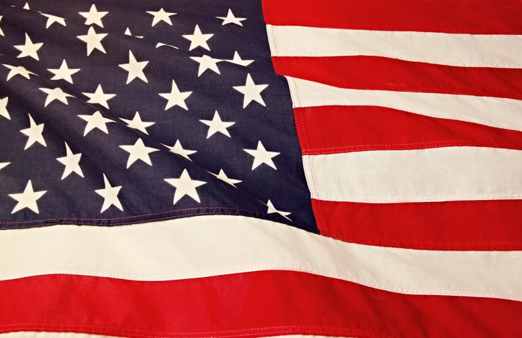 flag-of-america-1202723 Detailed image of the American flag showcasing the stars and stripes symbolizing USAs patriotism and pride.